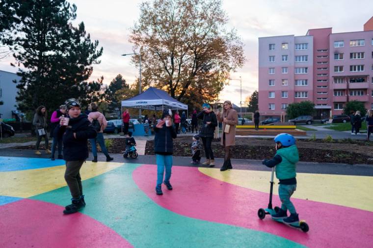 Děti na barevném Duhovém hřišti při otevření za účasti sousedů